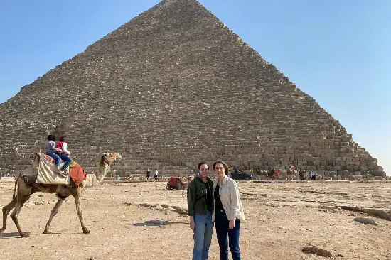 A family from a private Cairo trip from Hurghada in front of the Sphinx taking photos