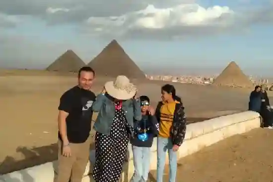 A happy family in front of the pyramids.
