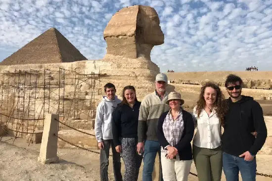 Tourists posing in front of the Great Sphinx of Giza on a private Cairo tour.