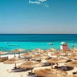 Shaded beach umbrellas and sunbeds at Paradise Island Hurghada.
