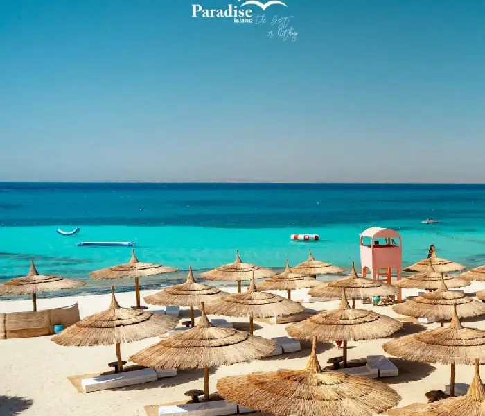 Shaded beach umbrellas and sunbeds at Paradise Island Hurghada.