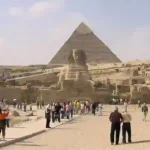 Camel riding at the Giza Pyramids during Cairo minibus trip.
