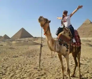 Camel riding at the Giza Pyramids during Cairo minibus trip.