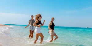 Three women enjoying the beach.