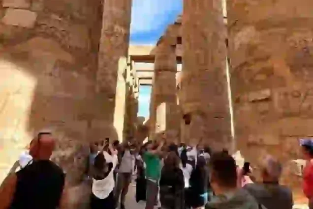 Small group of tourists enjoying Luxor day trip with expert guide.