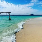 Crystal clear water and coral reefs at Hula Hula snorkeling spot.