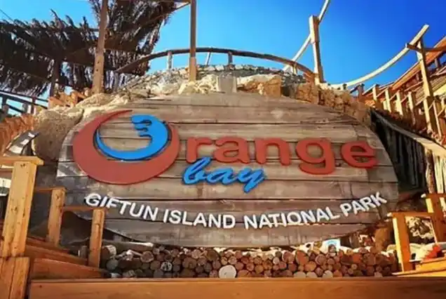 Crystal clear waters of Orange Bay Island visited by a private boat Hurghada tour.