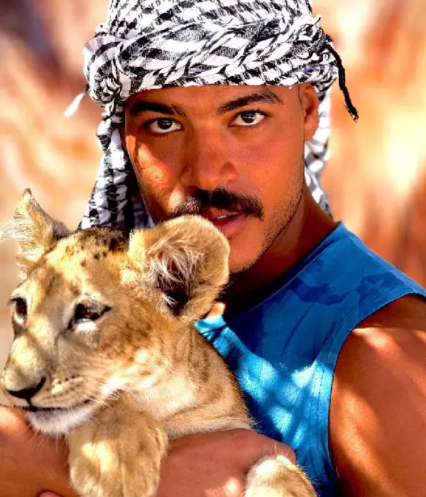Man holding a lion cub during private baby lion Hurghada photo experience